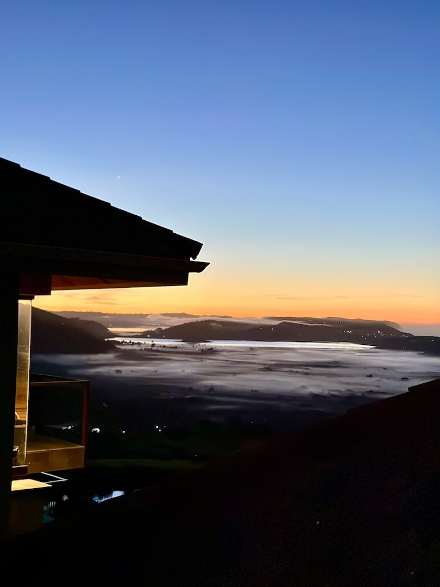 Dusk settling over the mist-filled valley
