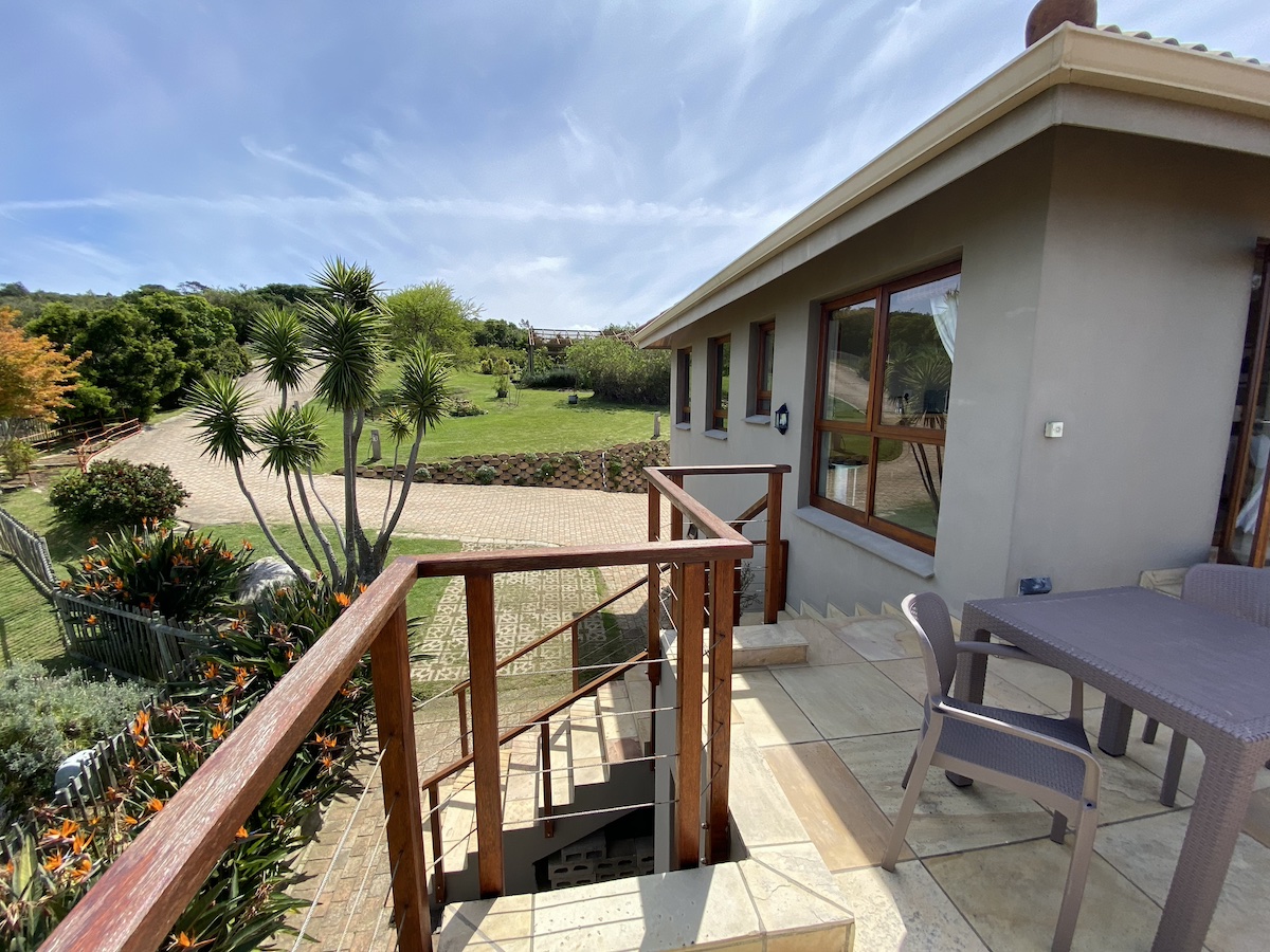 The stoep opening onto the lawn and garden, hills beyond